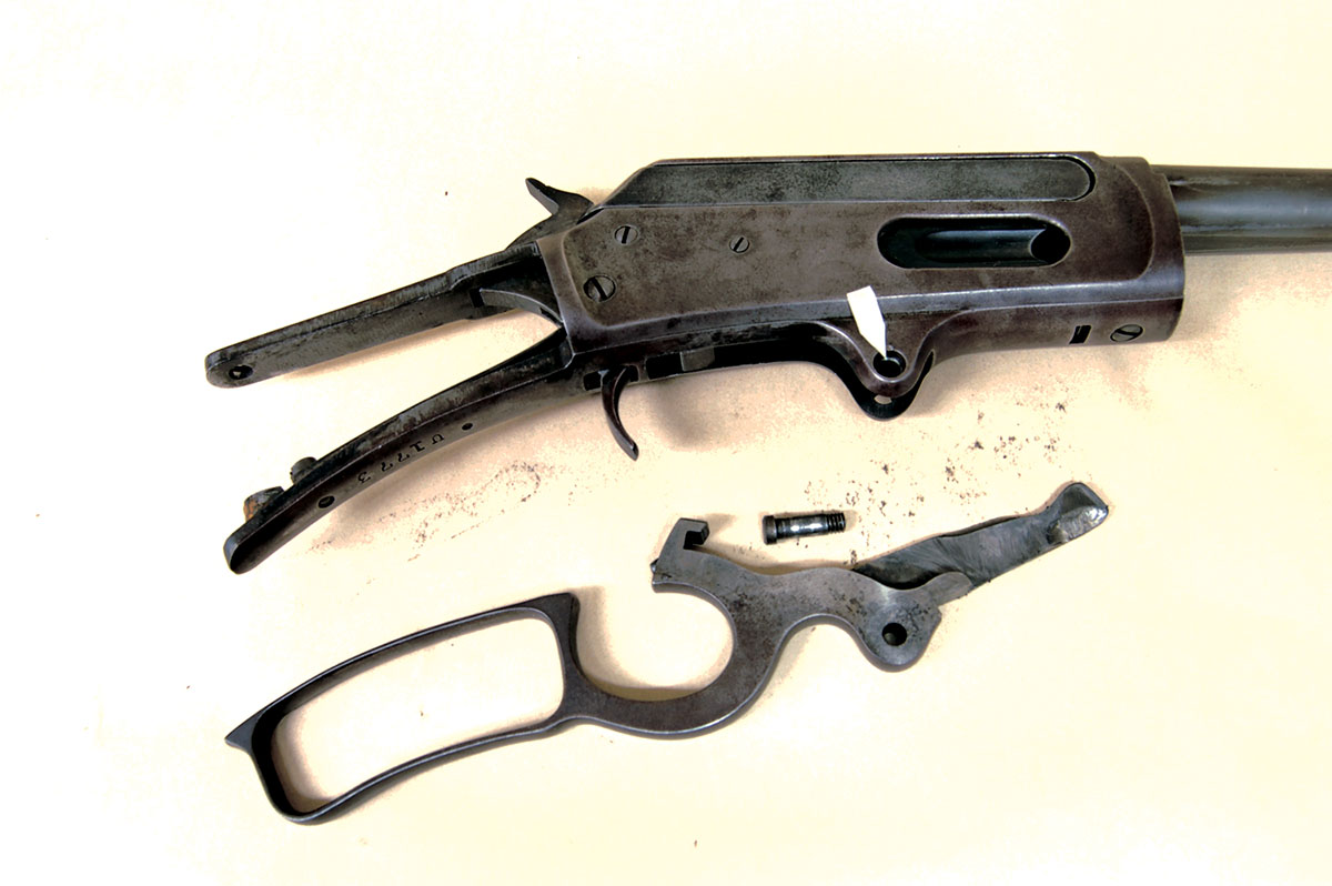 Remove the lever pivot screw from its recess (arrow), and the lever drops out of the bottom of the action.